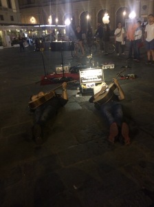 Two performers playing guitar laying down... 